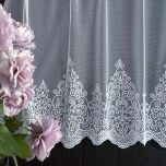 Subtle white curtain with embroidered ornamental design at the bottom 