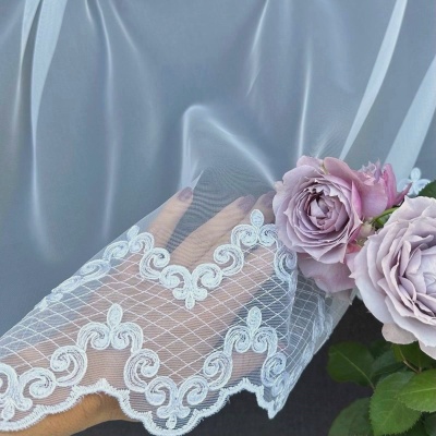 Subtle elegant curtain with white embroidered ornamental pattern 