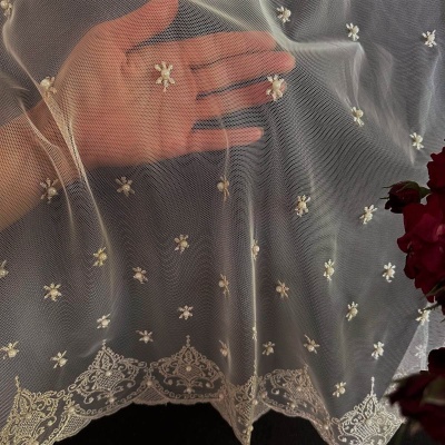 Stylish creamy curtain, embroidered, ornamental pattern with pearls