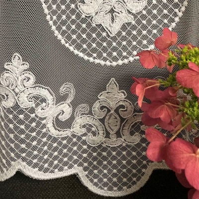 Stylish curtain with cream-colored embroidered ornamental